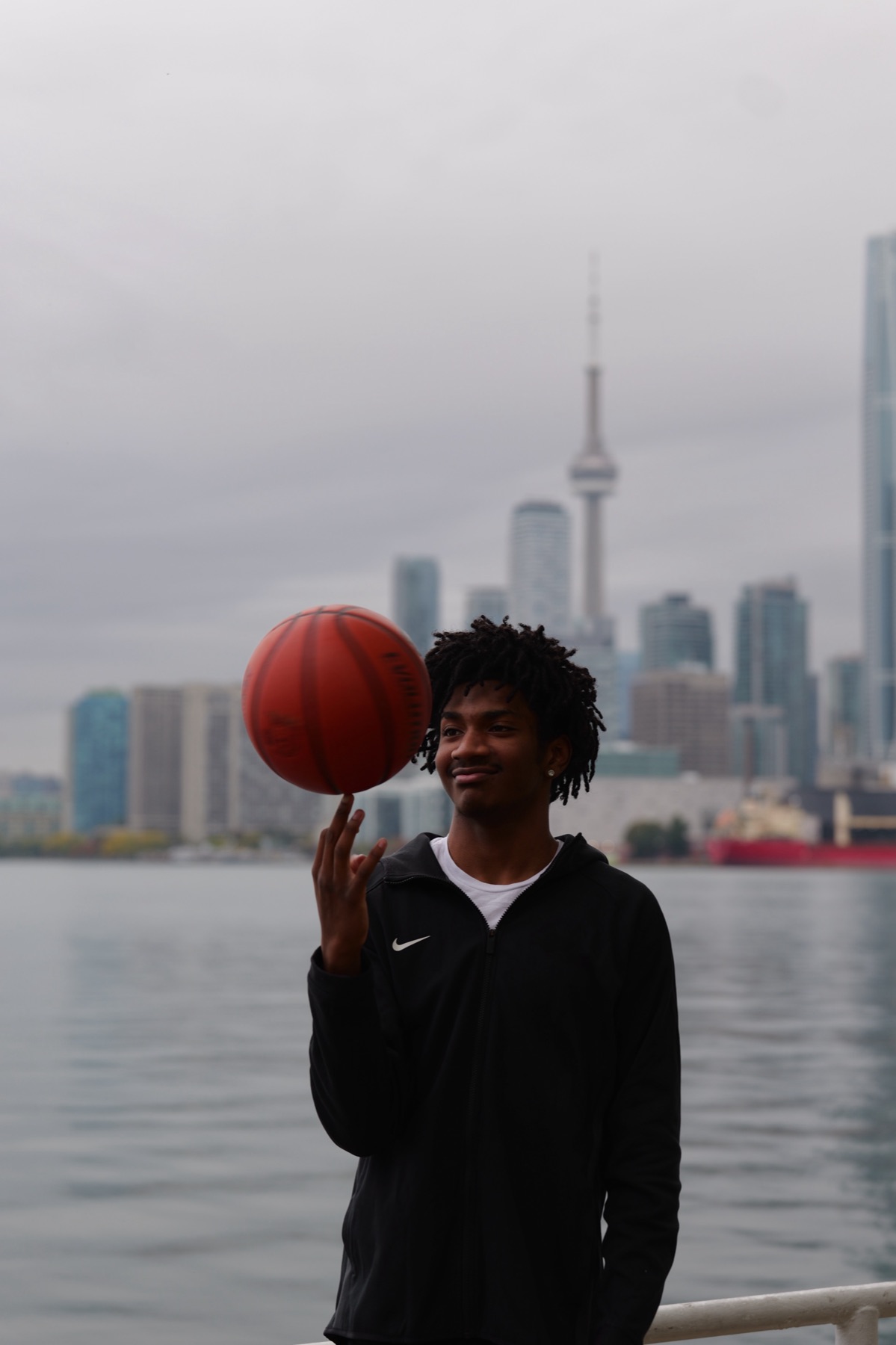 Xavier Maynard spinning a basketball on the Toronto waterfront